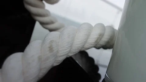 Twisted retro rope and tall white vase on black glass box Video stock 72652353