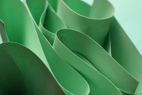 Twisted sheets of green paper as background Stock Photos