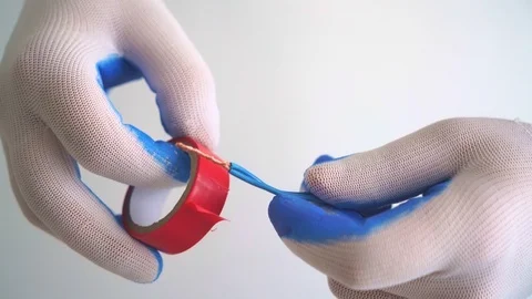 Twisted wire wrapping a red electrical tape. Wire insulation close up Stock Footage 121574392