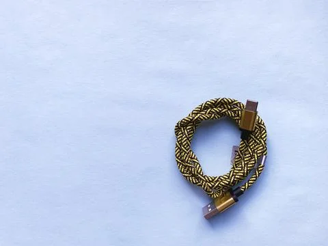 Twisted yellow USB cable on  blue Foto stock