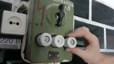 Twisting ceramic fuses on old electrical switchboard Stock Footage 100447026