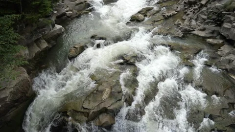 Twisting fizzy streams flowing down a waterfall in the Carpathians in slo-mo Stock-Footage 162155566
