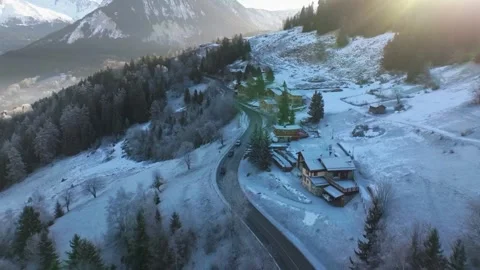 Twisting Mountain Road Through Snowy Hillside and Forest Vídeos de archivo 334320723