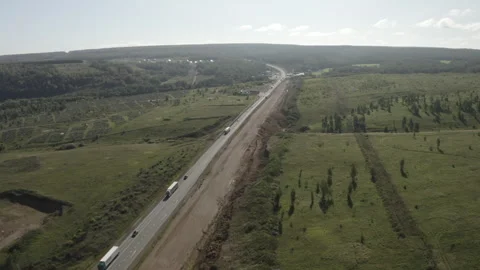 Twisting road amid rural fields and vibrant valleys Stock Footage 303112198