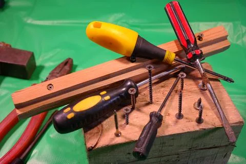 Twisting with a screwdriver. Working tools.Screwdriver and screws. work in th Stock Photos