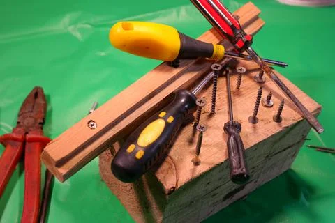 Twisting with a screwdriver. Working tools.Screwdriver and screws. work in th Фото