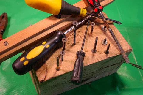 Twisting with a screwdriver. Working tools.Screwdriver and screws. work in th Photos