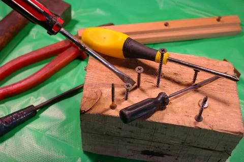 Twisting with a screwdriver. Working tools.Screwdriver and screws. work in th Stock Photos