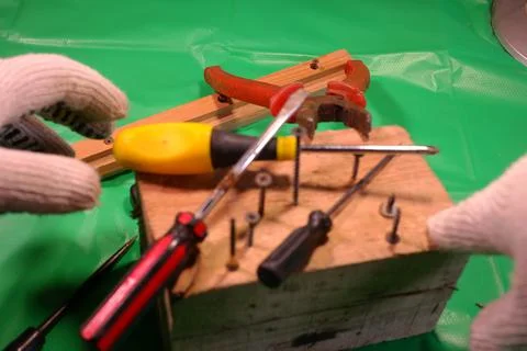 Twisting with a screwdriver. Working tools.Screwdriver and screws. work in th Stock Photos