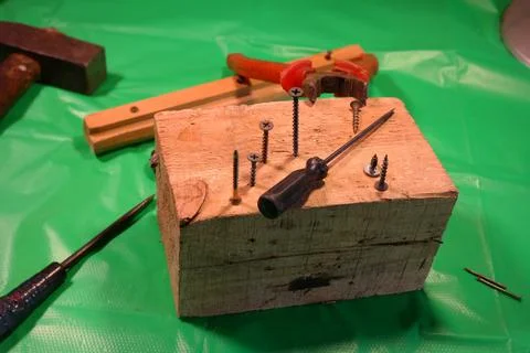 Twisting with a screwdriver. Working tools.Screwdriver and screws. work in th Photos