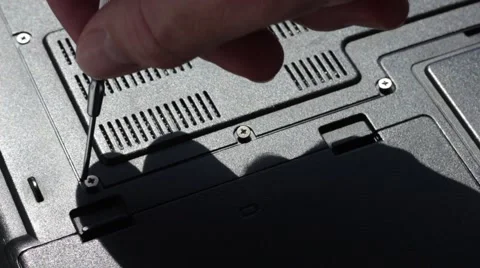 Twisting screws on a laptop's back Vídeo Stock 66755938