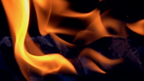 Twisting tongues of flame with flying small sparks on dark background Vidéo 108617101