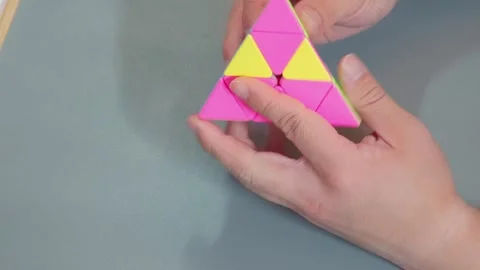 Twisting Triangle Pyramid Speedcube On Desk 스톡 동영상 339124165
