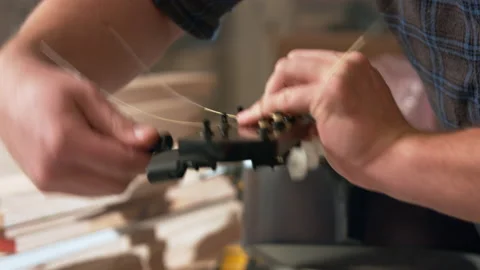 Twisting the tuning knobs with a tool. at the end of the neck the guitar 動画素材 132260874