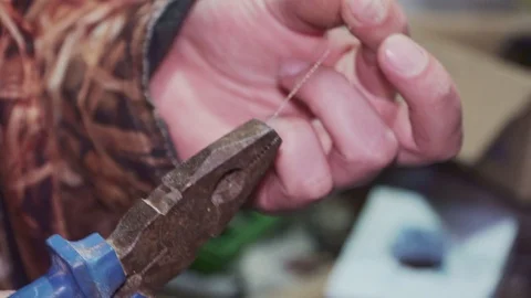 Twisting the wire with pliers close-up Stock Footage 102176715