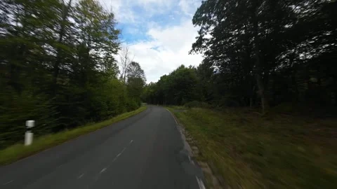 Twisty driving road through the german Eifel region, hills and forrest road Stock Footage 289670179