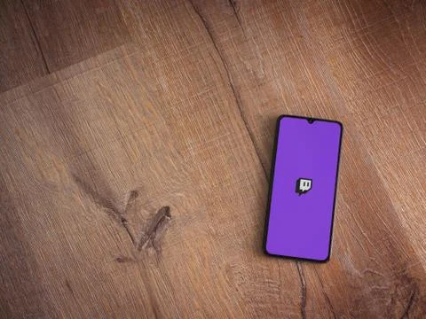 Twitch app launch screen with logo on the display of a black mobile smartphon Stock Photos