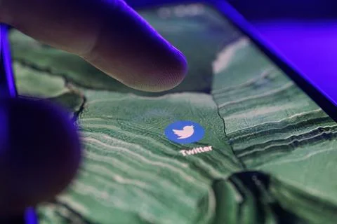 Twitter app on smartphone screen. Close up shot of Twitter app Stock Photos
