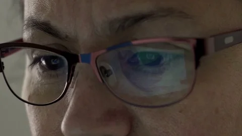 Twitter Logo Reflection in Glasses of Middle Aged Female Stock Footage 75043038
