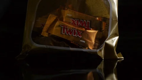 Twix minis cookie bars on black background. Stock Footage