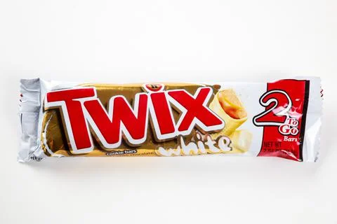 Twix white chocolate cookie bars with caramel on white background. Stock Photos