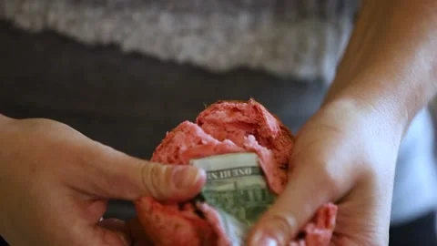 Two 100 dollar bills hidden in a baked muffin. Stock Footage 145721293