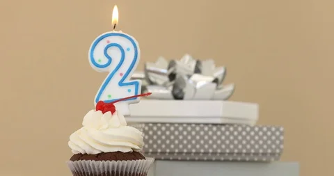 Two 2 candle in cupcake pastel background Video stock 89255365