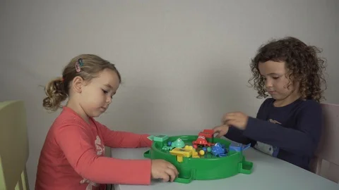 Two 5 and 3 year old girls play with a board game Stock-Footage 97237280
