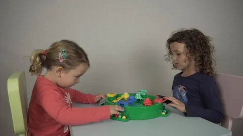Two 5 and 3 year old girls play with a board game Stock-Footage 97237376