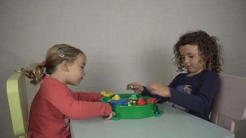 Two 5 and 3 year old girls play with a board game Stock-Footage 97237404