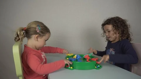 Two 5 and 3 year old girls play with a board game Stock Footage 97237443