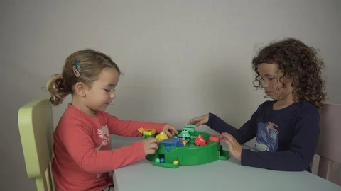 Two 5 and 3 year old girls play with a board game Stock-Footage 97237939