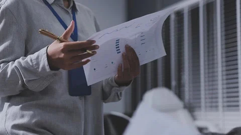 Two accountants examining financial documents using a calculator, taking no.. Stock Footage 336017886