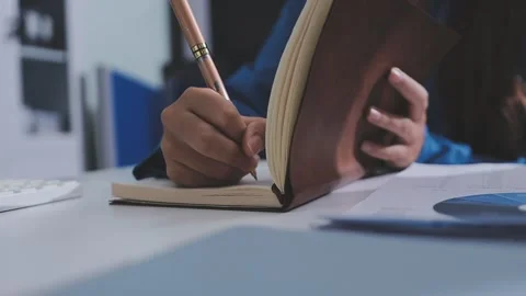 Two accountants examining financial documents using a calculator, taking no.. Stock Footage 336018236