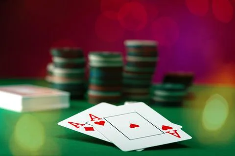 Two aces and stack of Casino Chips in background Stock Photos