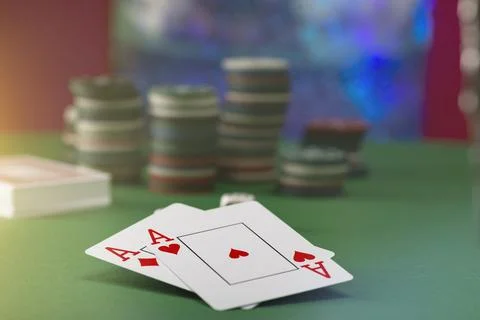 Two aces and stack of Casino Chips in background Stock Photos