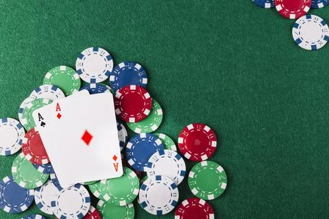 Two aces playing cards chips green poker table Photos