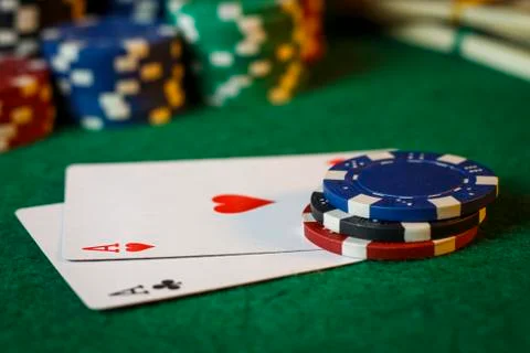 Two aces on the poker table with chips Stock Photos