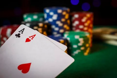 Two aces on the poker table with chips Stock Photos