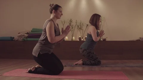 Two active women synchronously doing yoga exercises Video stock 106119728