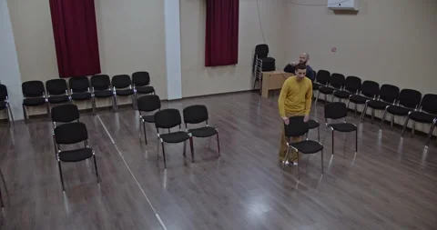 Two Actors Rehearse Blocking and Movement on a Minimalist Theater Stage for an Stock Footage 312079087