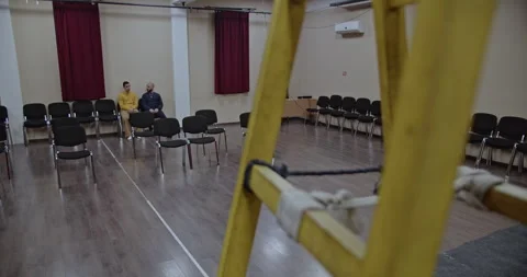 Two Actors Rehearse a Scene on Stage in a Theater, Preparing for an Upcoming Stock Footage 312079687