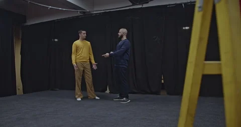 Two Actors Rehearse on a Theater Stage, Discussing and Practicing Their Lines Stock Footage 312072865