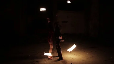 Two actors show fire show in an old aircraft hangar. Vídeo Stock 79676641