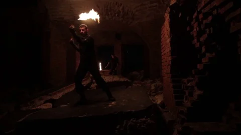 Two actors show fire show in the old German fort. Stock Footage 79699728
