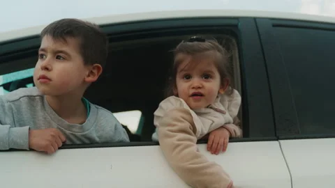 Two adorable children, looking out of a window car, looking at a landcape view Stock Footage 238002210