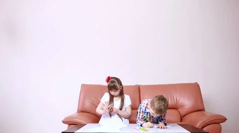 Two adorable happy children drawing with crayons at playschool. girl with Down Stock Footage 63463904