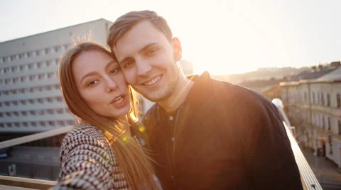 Two adorable people in love feeling happy to be together and taking selfies to Stock Footage 61844094