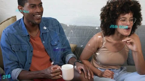 Two adults sitting on gray sofa starting conversation, sparking crypto nodes Stock Footage 333033729