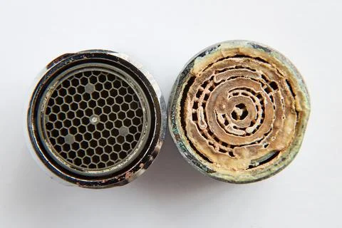 Two aerators clean and dirty with limescale deposits Stock Photos